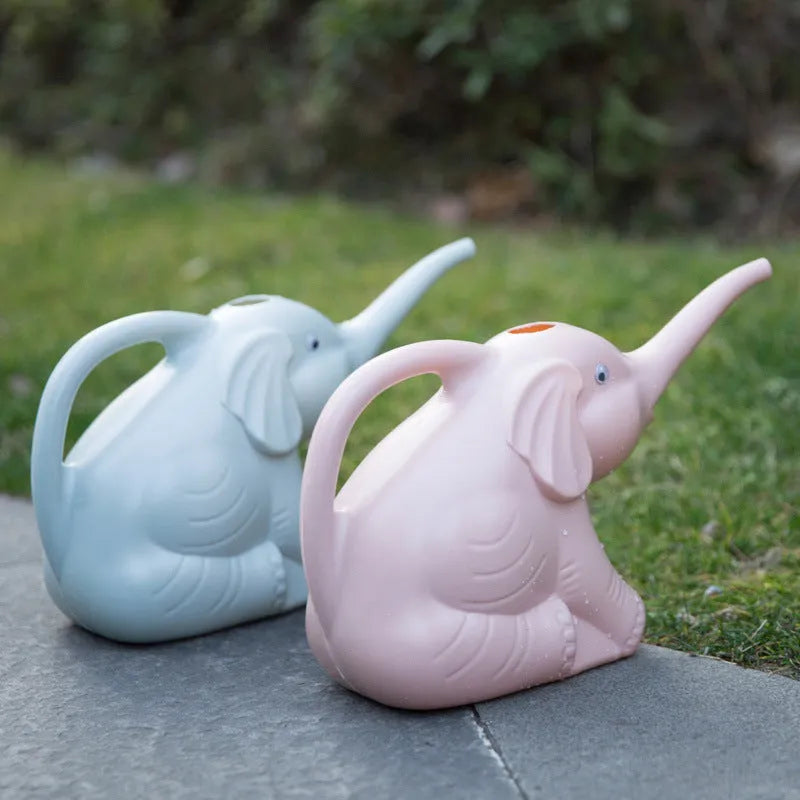 Blue plastic children's watering can shaped like a baby elephant with a long nozzle and bottle-style handle.