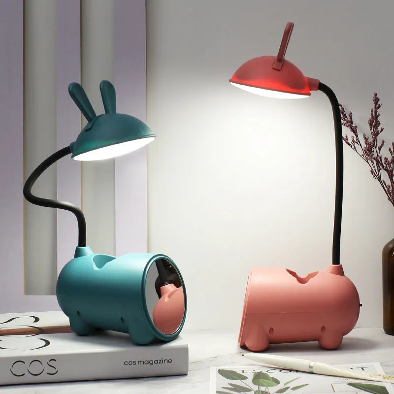 Simple cartoon-style USB desk lamp with pen holder base in green, dark blue, or pink