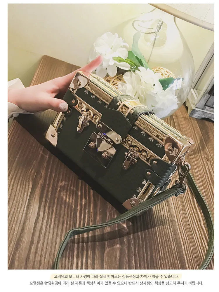 Women's black hard PU leather shoulder bag with single strap and decorative rivet detailing