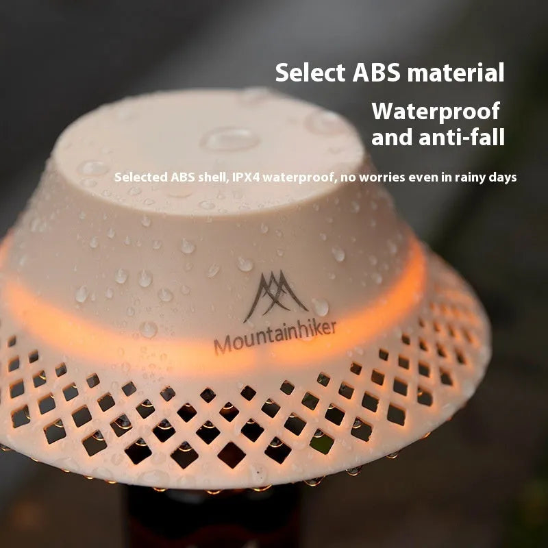 Beige wine bottle shaped camping lantern with USB-C port and adjustable light settings on a wooden table.