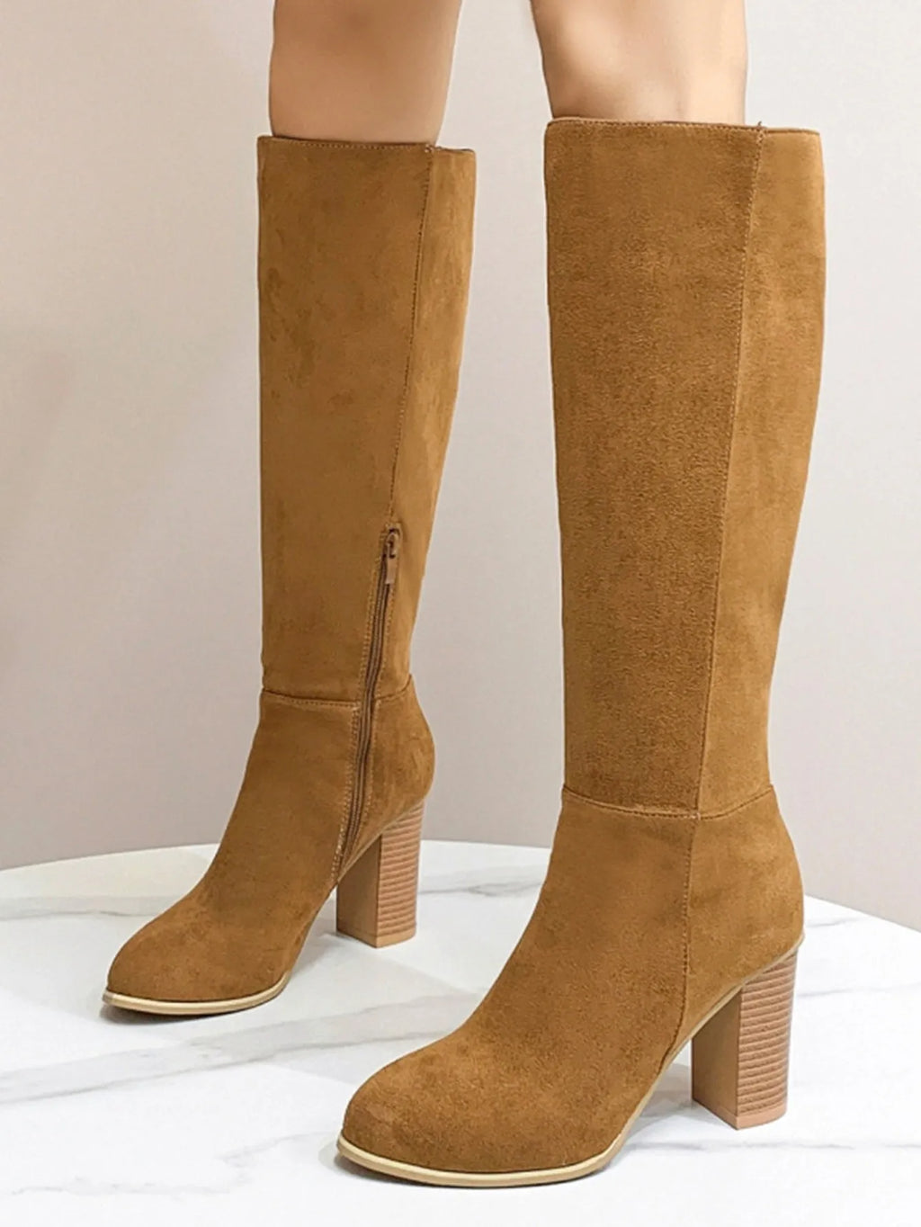 Women's black square toe high heel fashion boots made from artificial PU leather.