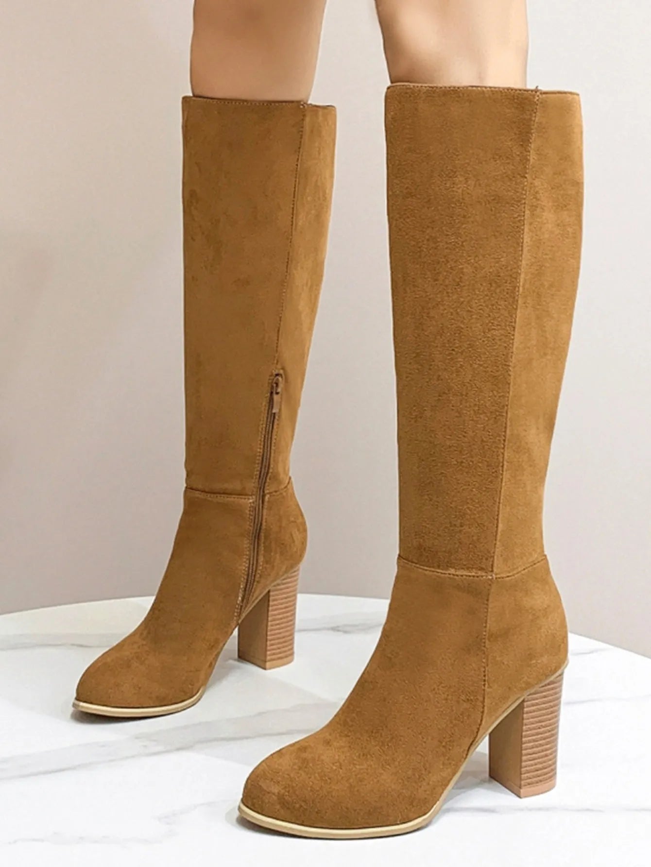 Women's black square toe high heel fashion boots made from artificial PU leather.