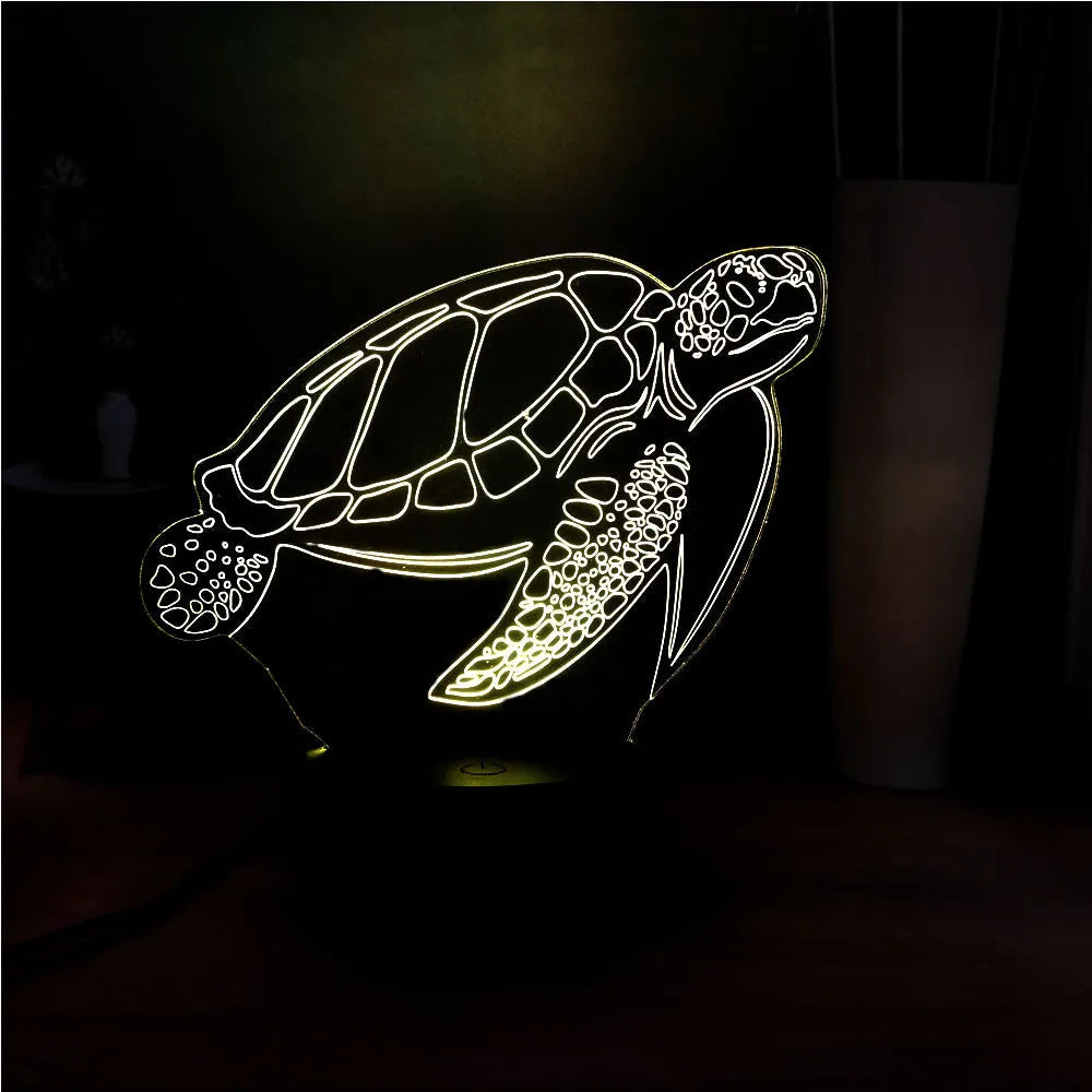 3D clear acrylic turtle-shaped LED night light with multi-colour glow on a surface.
