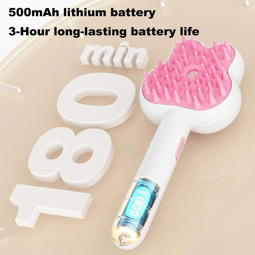 Rechargeable pink cartoon-design steam brush comb for grooming cats and dogs on a table.