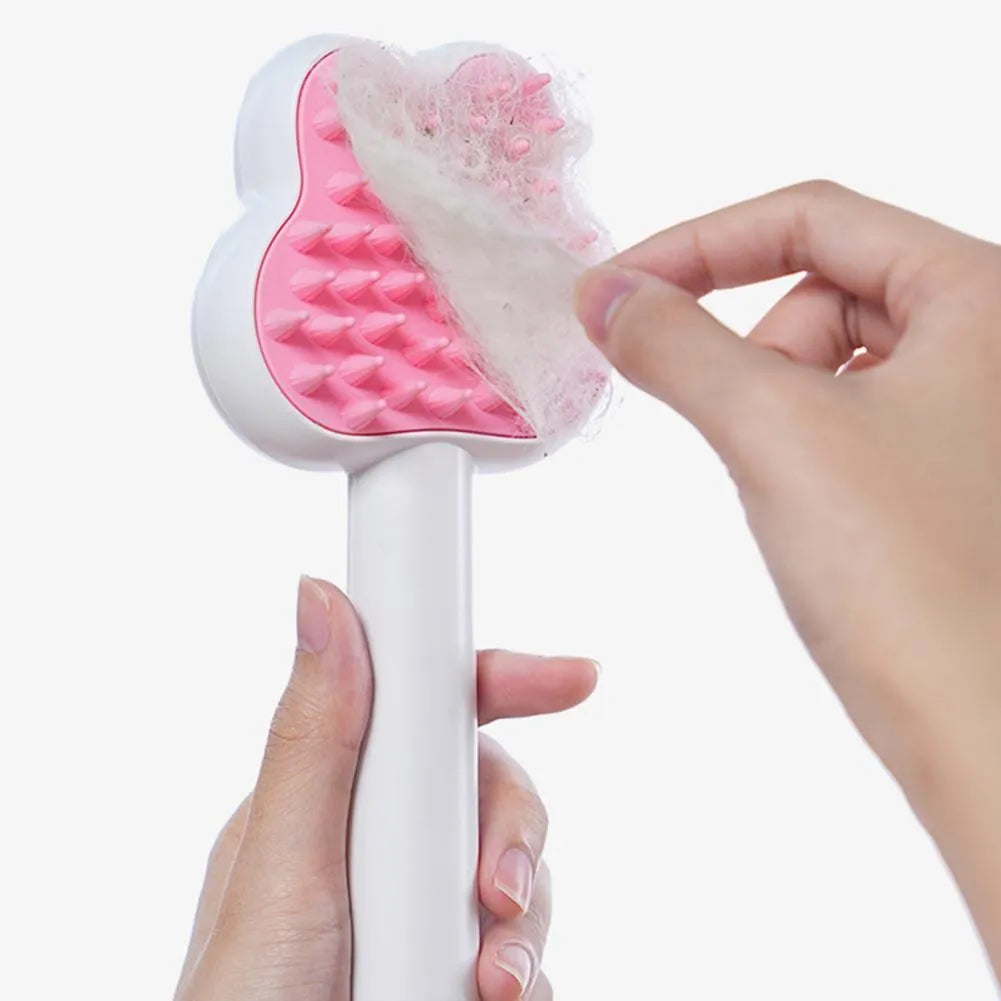 Rechargeable pink cartoon-design steam brush comb for grooming cats and dogs on a table.