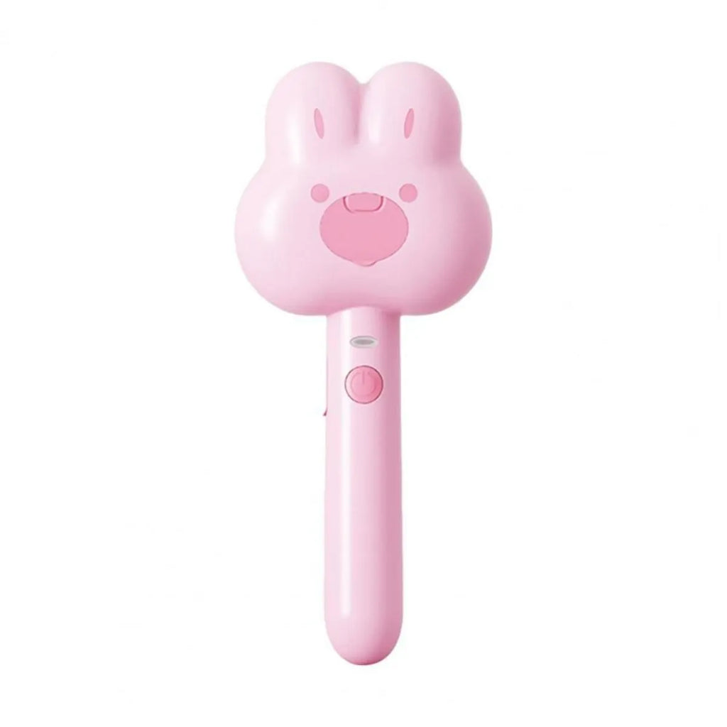 Rechargeable pink cartoon-design steam brush comb for grooming cats and dogs on a table.