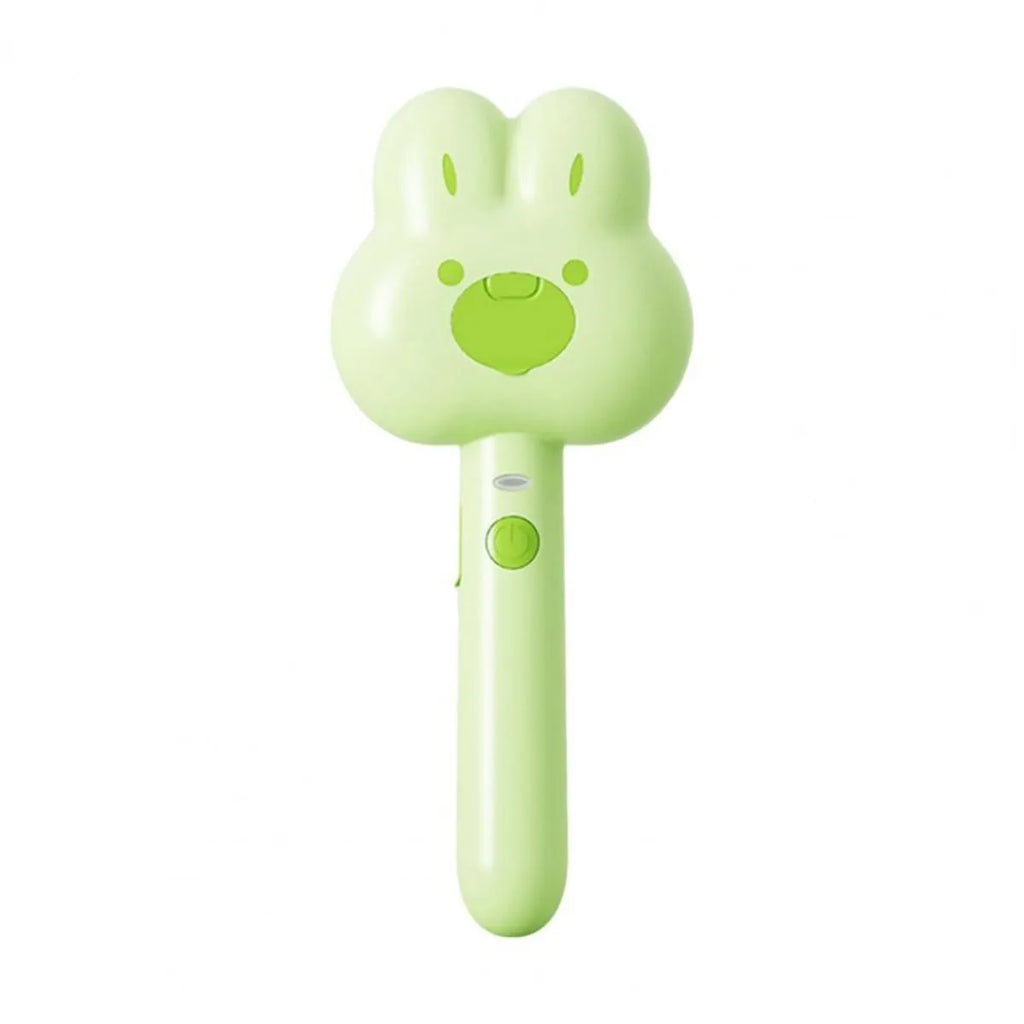 Rechargeable pink cartoon-design steam brush comb for grooming cats and dogs on a table.