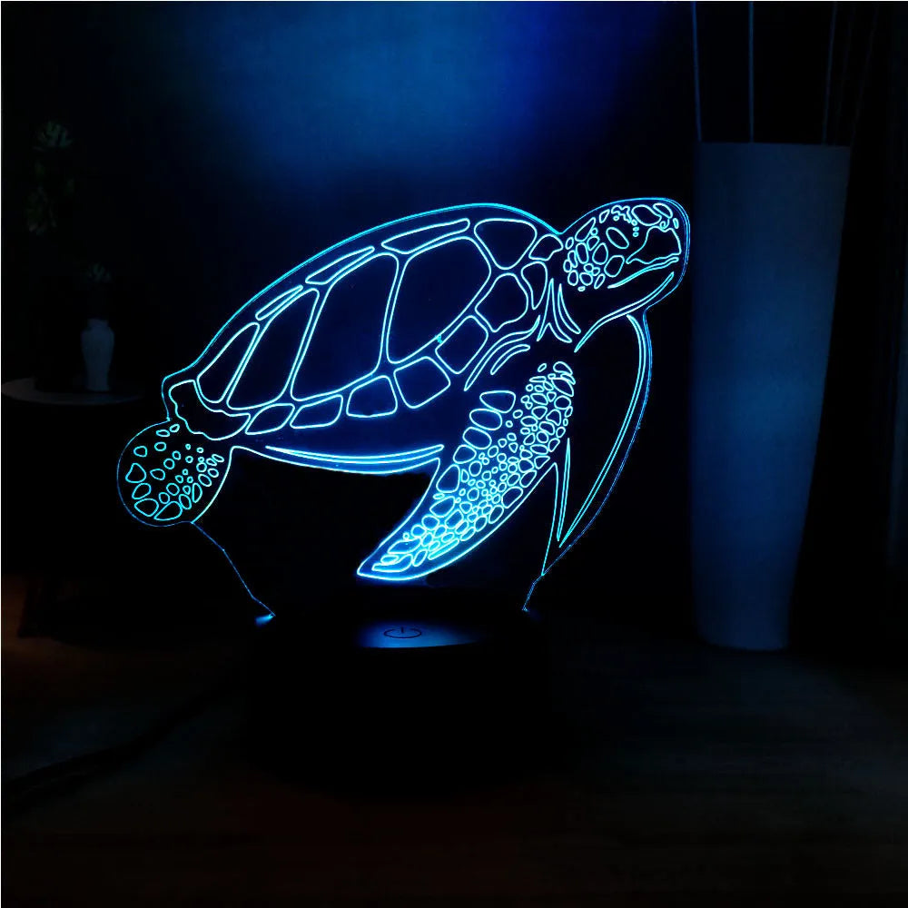 3D clear acrylic turtle-shaped LED night light with multi-colour glow on a surface.
