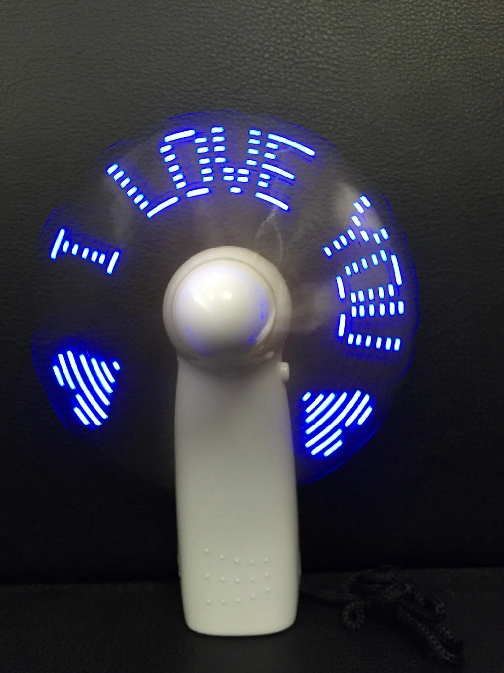 White handheld mini fan with a flashing blue and red LED 'I Love You' heart pattern on the front.