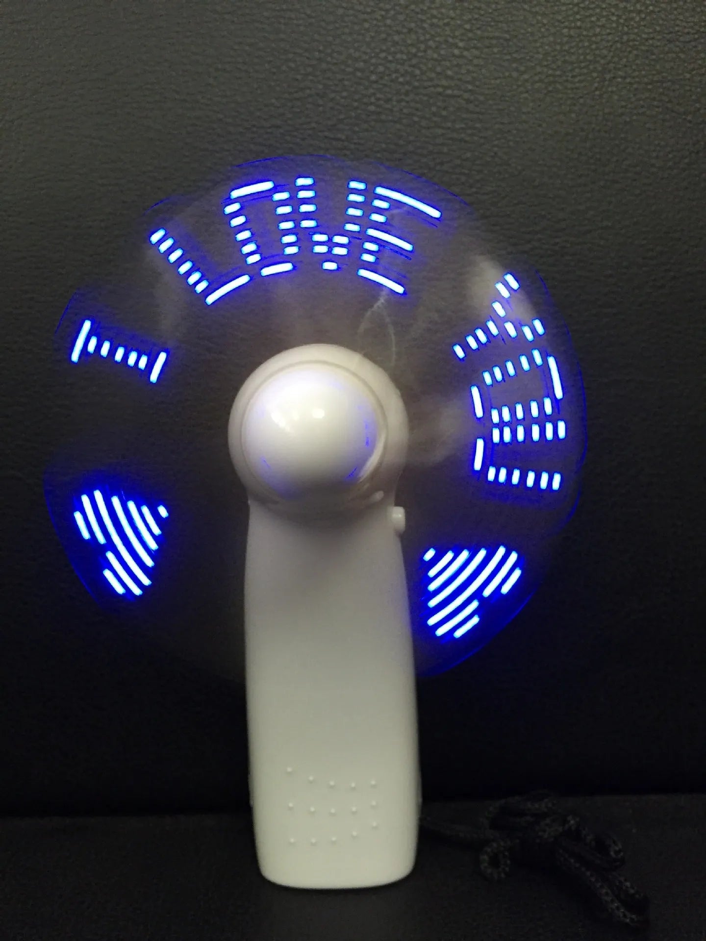 White handheld mini fan with a flashing blue and red LED 'I Love You' heart pattern on the front.