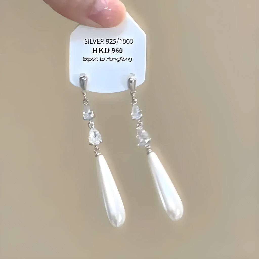 Geometric alloy ear clips with heart shape, rhinestone stars, and tassel details on a white background.