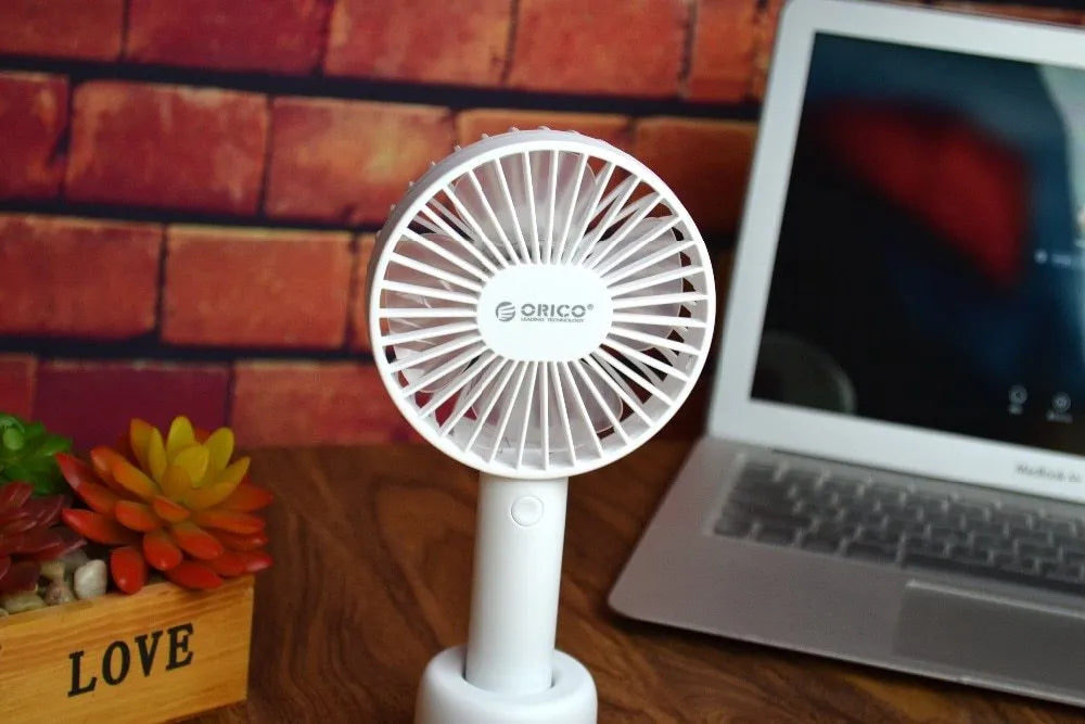 ORICO FH1 white portable USB rechargeable fan with three-speed settings on a desk.
