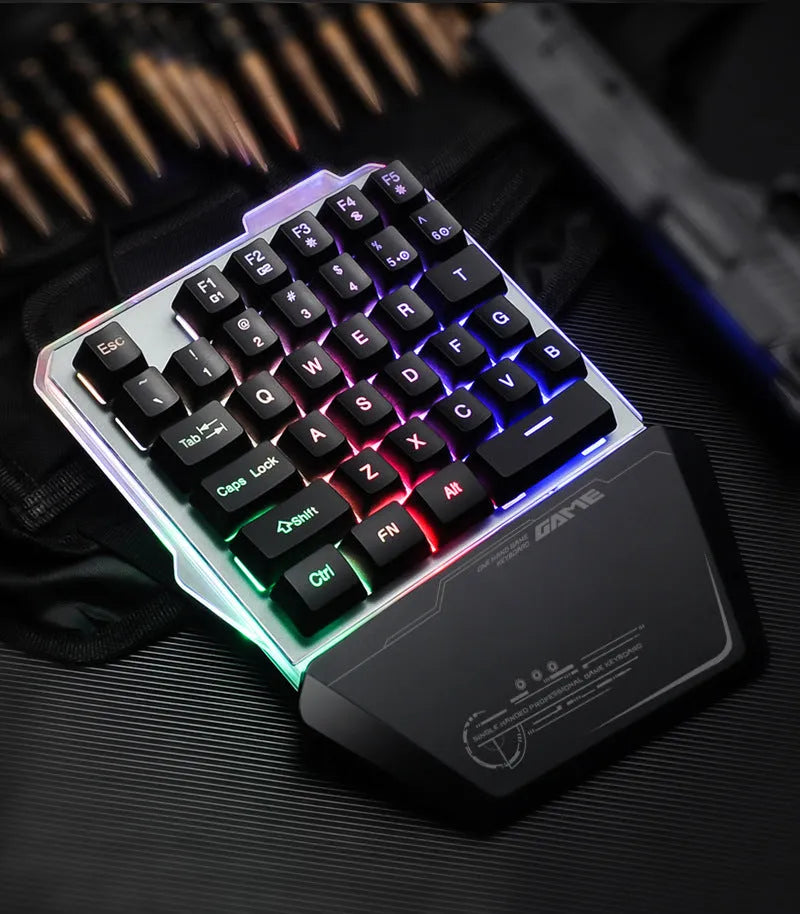 Black robotic one-handed gaming keyboard with RGB backlit keys and USB cable