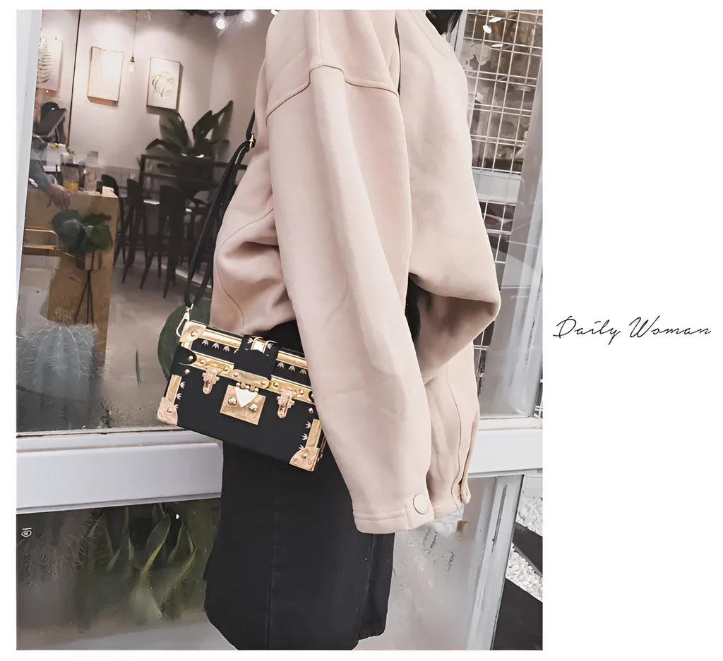 Women's black hard PU leather shoulder bag with single strap and decorative rivet detailing