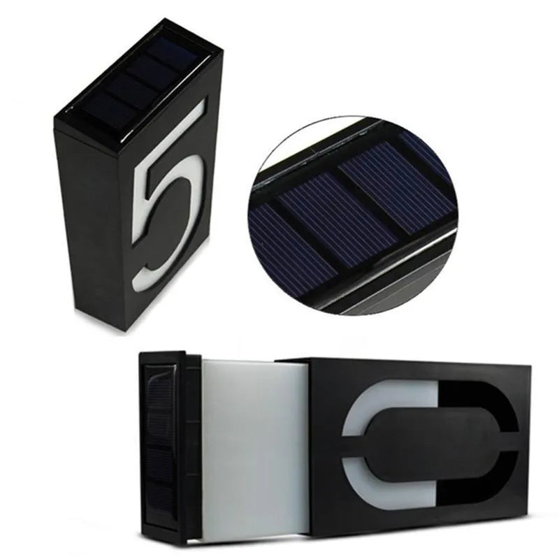 Solar-powered white LED house number light with IP65 waterproof rating mounted on an outdoor wall.