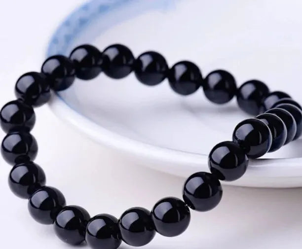 Black onyx geometric bracelet with 8mm beads on a stretchy elastic cord.