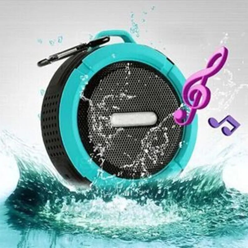 Colourful waterproof portable Bluetooth speaker with a black mounting buckle clip.
