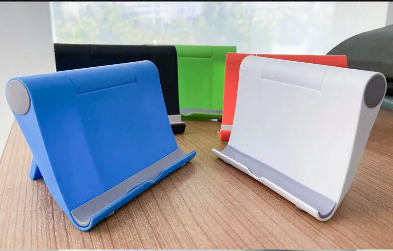 Black PE folding mobile phone and tablet stand on a wooden desktop, shown in an open, angled position.
