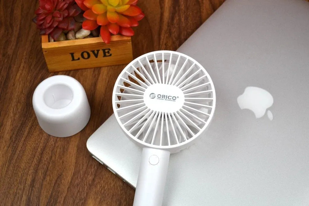 ORICO FH1 white portable USB rechargeable fan with three-speed settings on a desk.