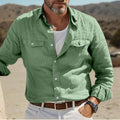 Men's long-sleeved loose fit casual shirt in a cotton linen blend, shown in green, on a hanger.