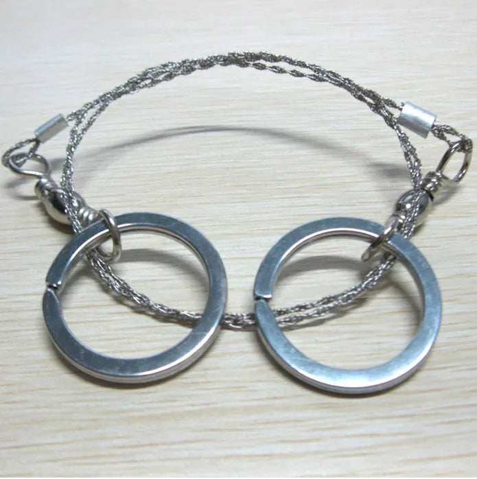 Stainless steel survival wire saw with thumb rings showing 55cm blade and pull ring assembly