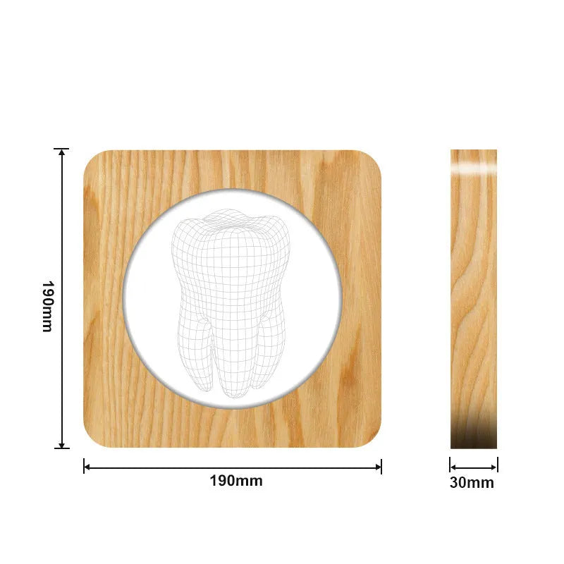 Tooth-shaped wooden-coloured acrylic night lamp with USB cable on wooden surface