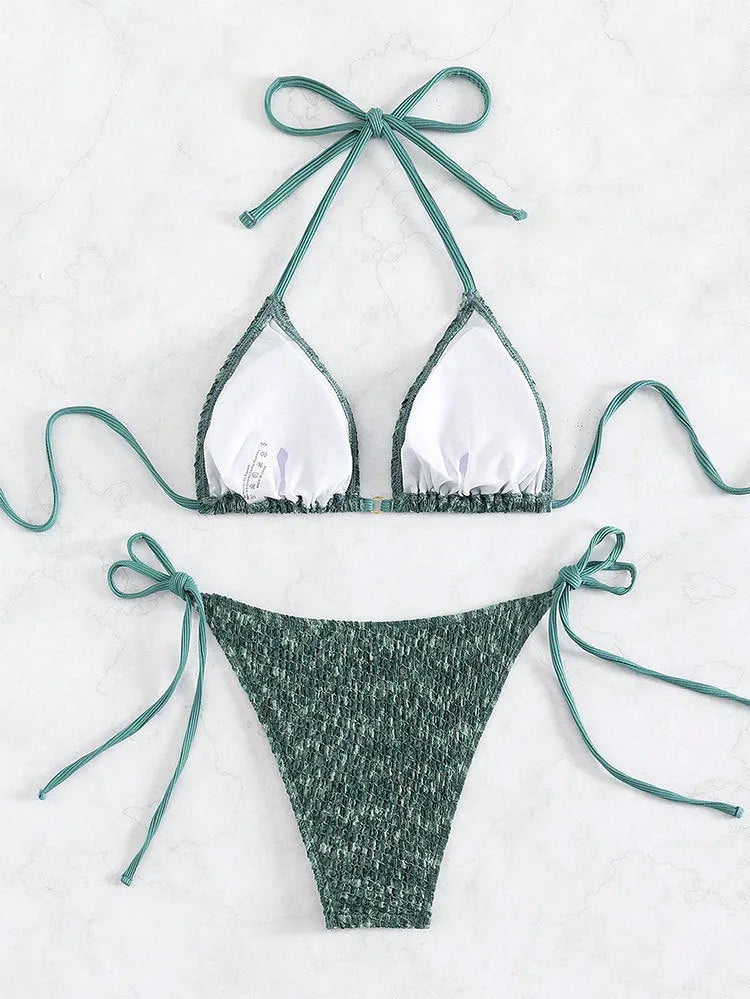 Women's green halter strap backless swimsuit bikini with three-point neck design on mannequin