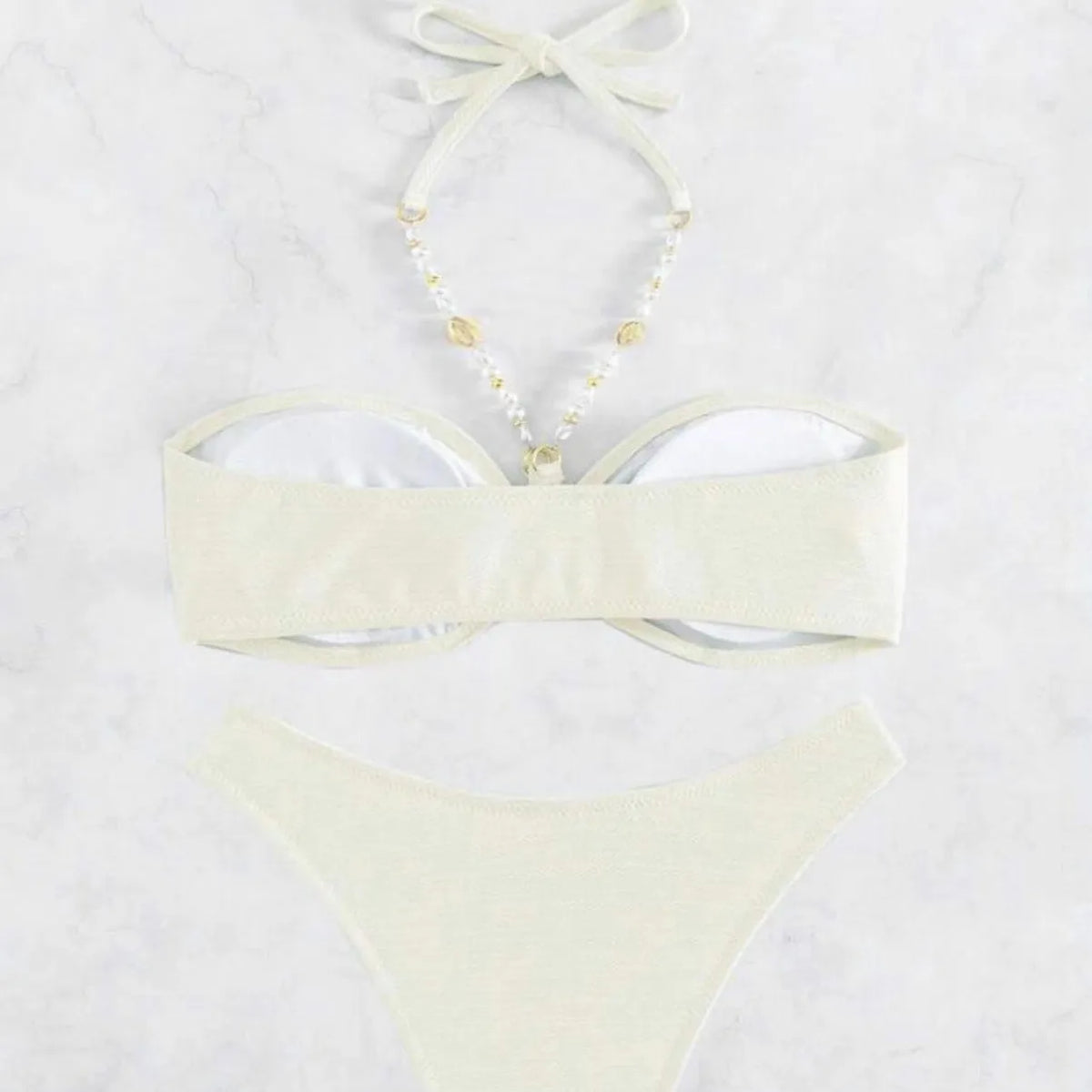 Women's pure colour halter neck bikini set on a hanger, shown in creamy-white.