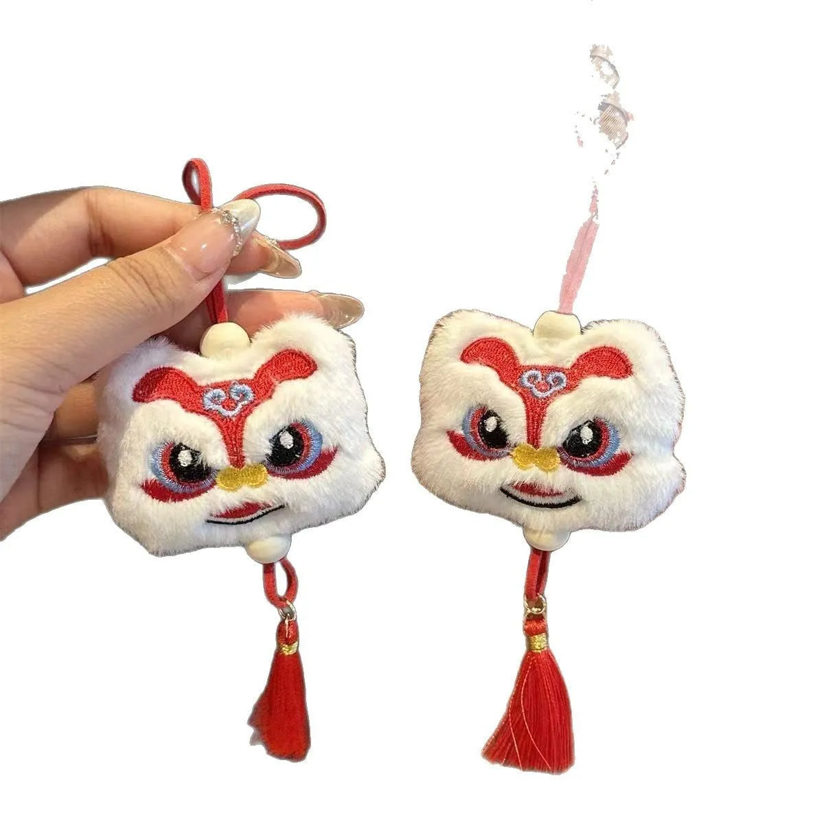Blue and yellow handmade plush cartoon lion keychain with long tassel and star stone decoration.