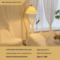 Retro-style vertical table lamp with log white lampshade placed on a sofa arm.