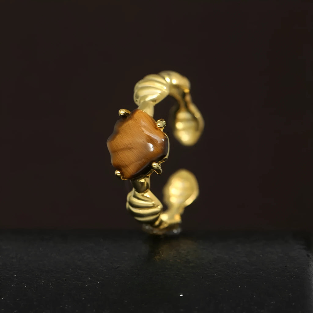 Women's adjustable silver ring featuring a shell and tiger eye stone with an electroplated gold tone finish.