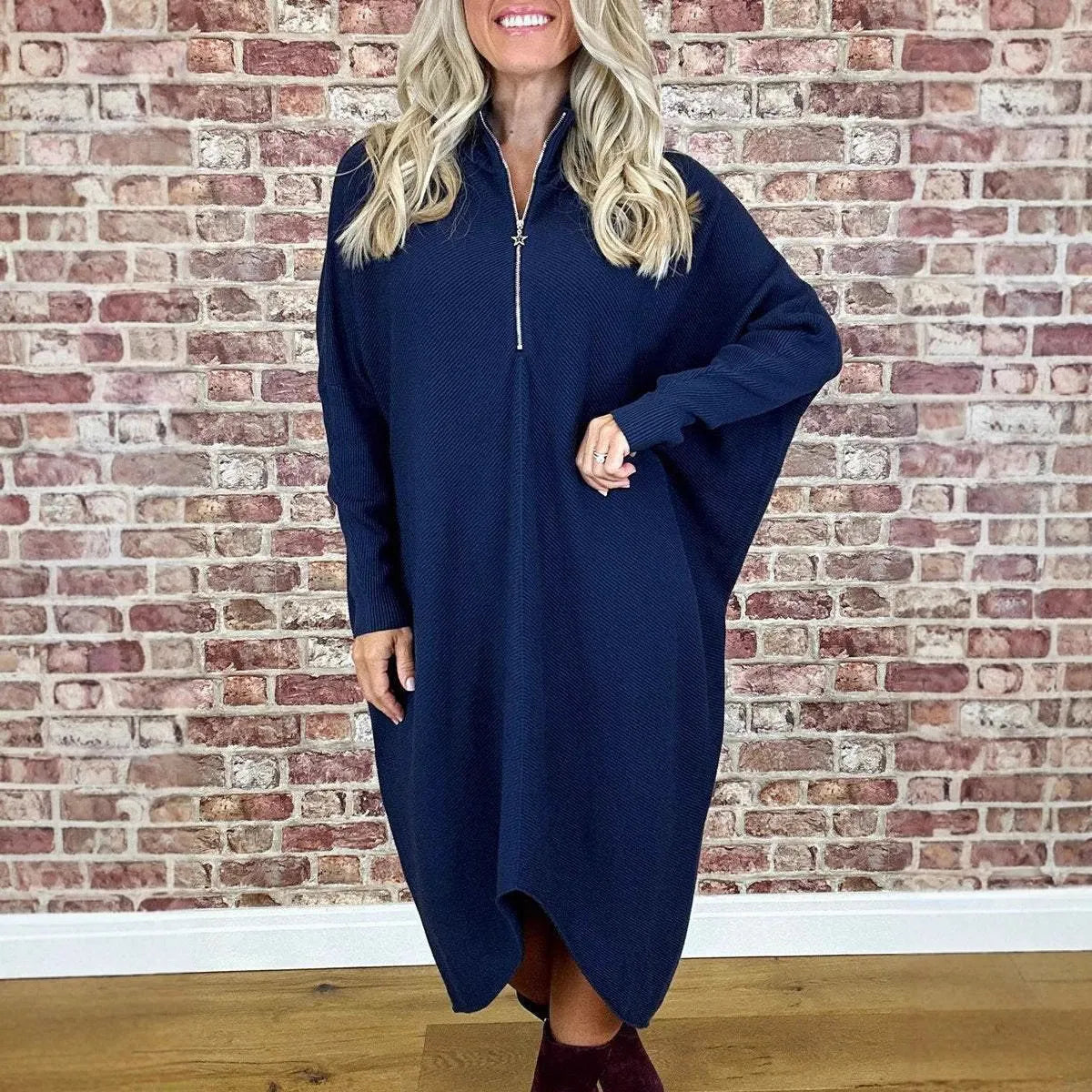 Women's solid colour loose fit knitted dress with raglan sleeves and a front zipper detail.