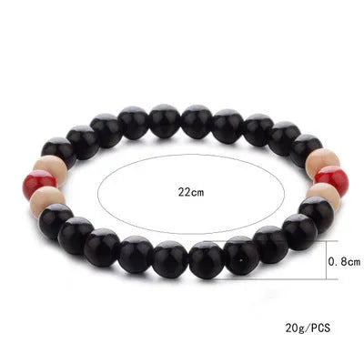 Natural stone beaded bracelet with lava stones on a wrist, showing ethnic style and unisex design.