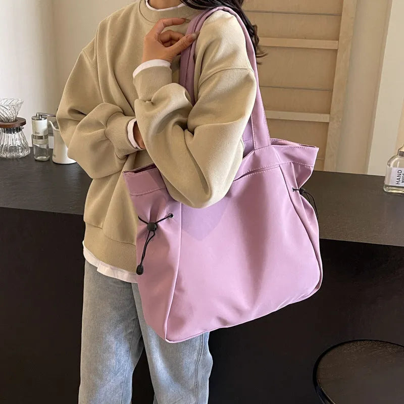 Soft Oxford cloth foldable tote bag in street style, shown in available colours.