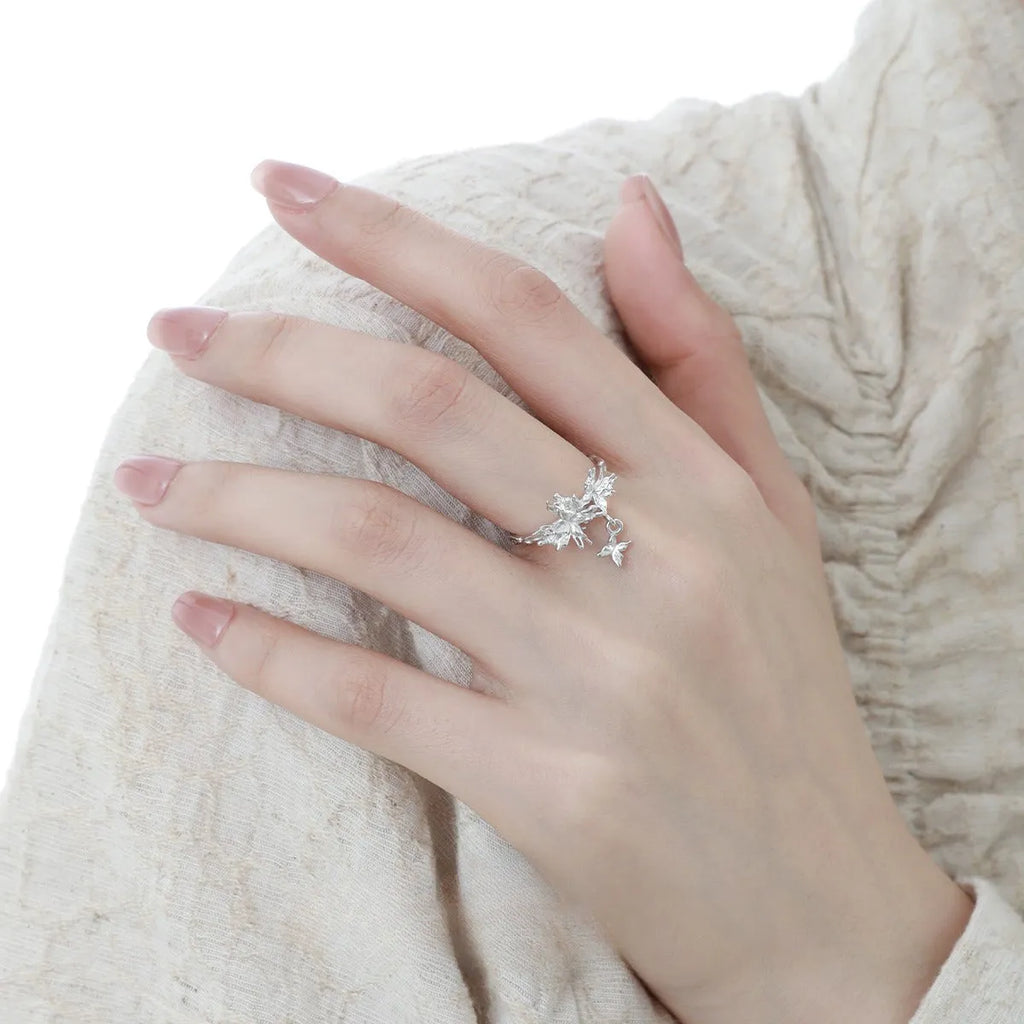 Women's adjustable silver ring with a wild butterfly design, shown in white gold and 18K gold colour finishes.