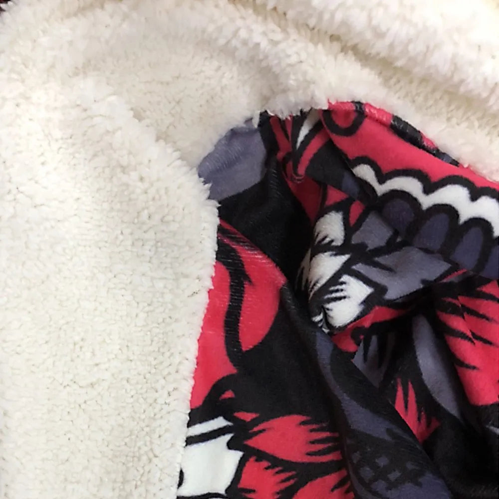 Round coral-coloured flannel burrito blanket with a delicious food print, folded to show soft texture.
