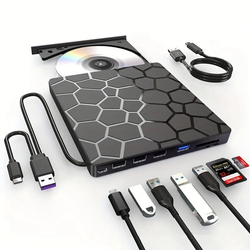 Black external USB CD drive and writer on a desk next to a laptop.