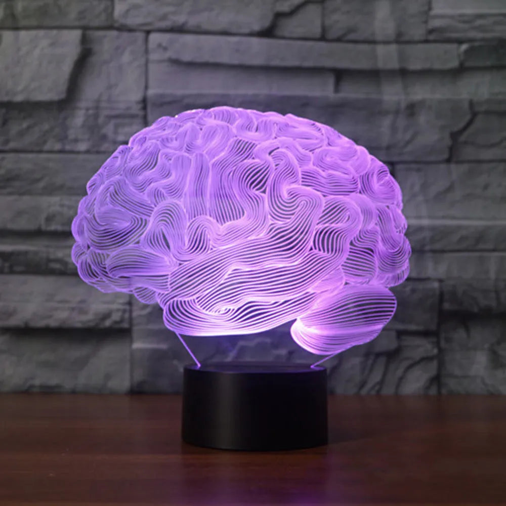 3D acrylic brain-shaped LED lamp with remote control on a wooden desk, projecting colourful light