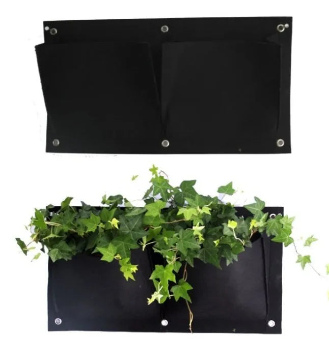 Green felt vertical wall planter with multiple pockets hanging on an outdoor wall