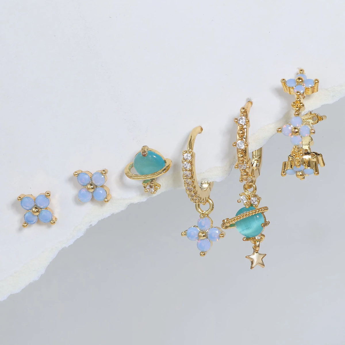 Gold and silver Japanese Korean style flower ear studs with blue flower nail and zircon mosaic design.