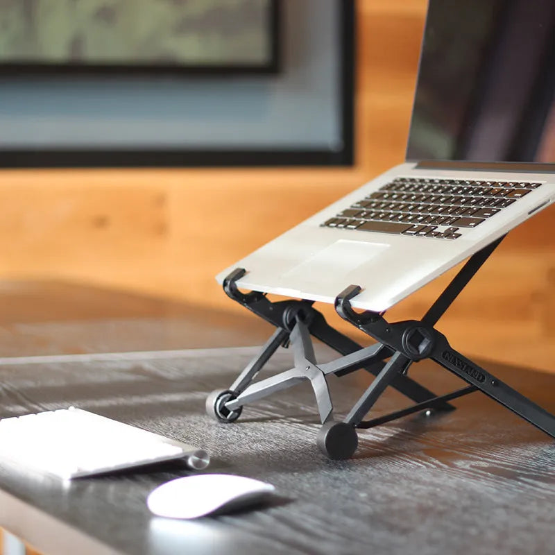 Black folding laptop stand with reinforced nylon construction showing compact folded position