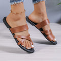 Men's round-head one-line casual beach slippers in black with hollow-out design on a sandy background.