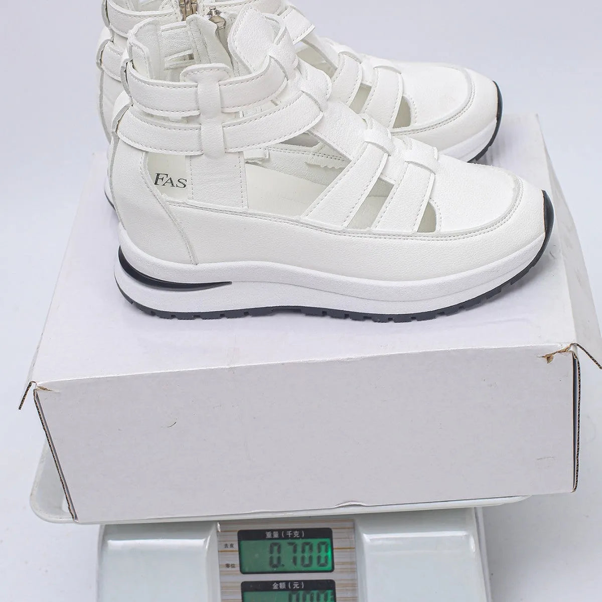 Women's black close-toed hollow-out platform sandals with Velcro strap on a white background.
