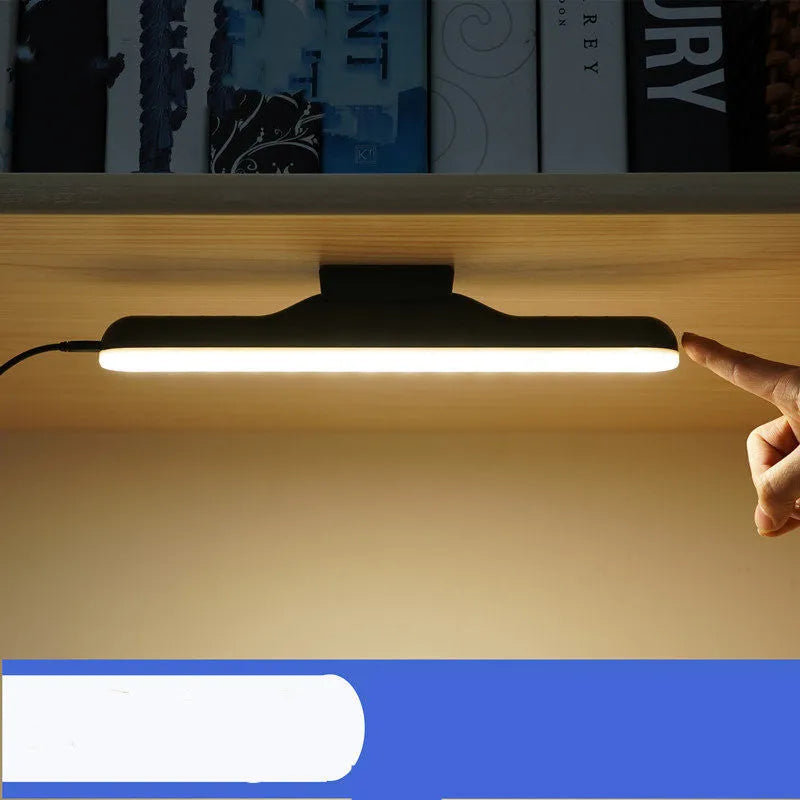 Modern white plastic smart desk lamp with touch control and adjustable LED light on a wooden desk.