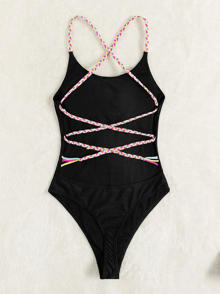 Black solid colour women's one-piece swimsuit with a backless and sleeveless design on a mannequin.