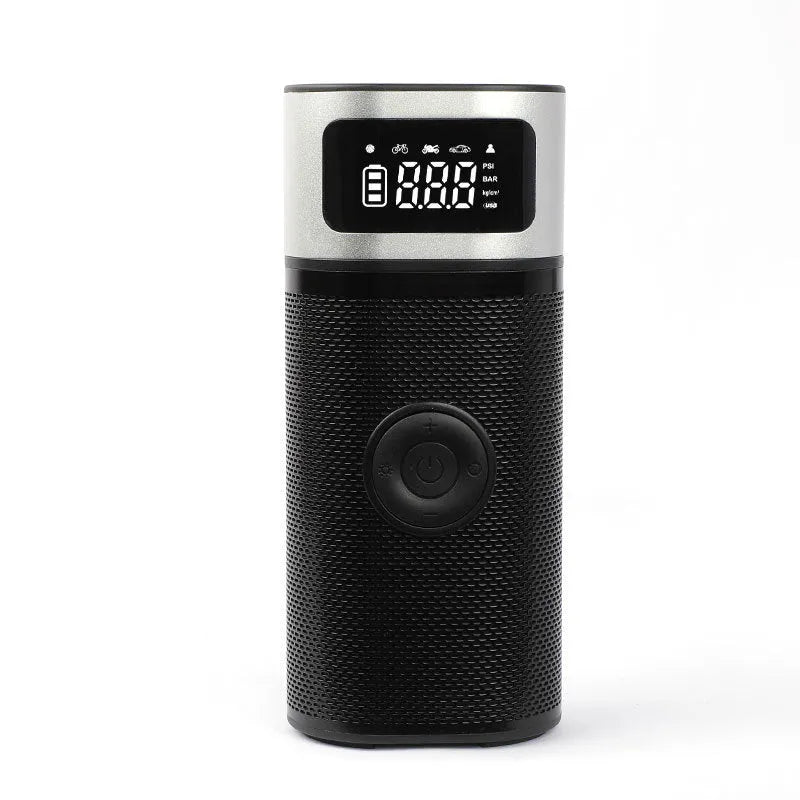 Black portable wireless air pump with digital display, LED light, and attached inflation tube on a textured surface.