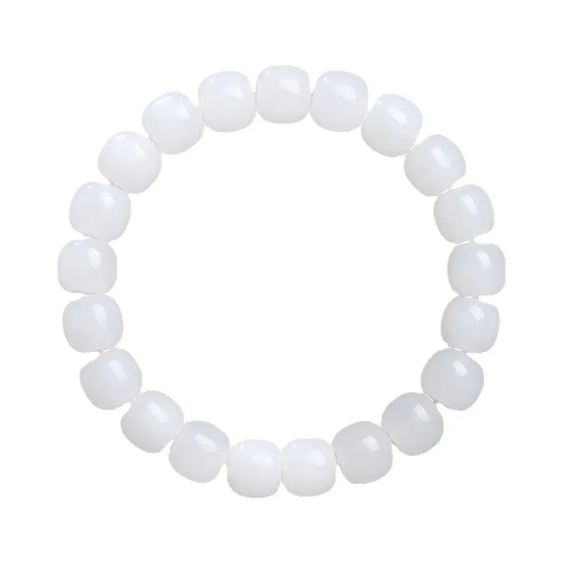 White Hetian jade barrel bead bracelet on a wrist, showing three bead size options.