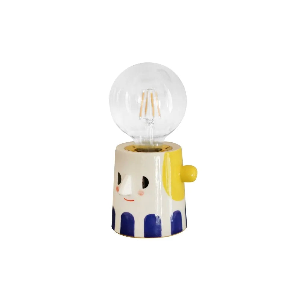 Handmade ceramic table lamp with ball-shaped shade on wooden surface
