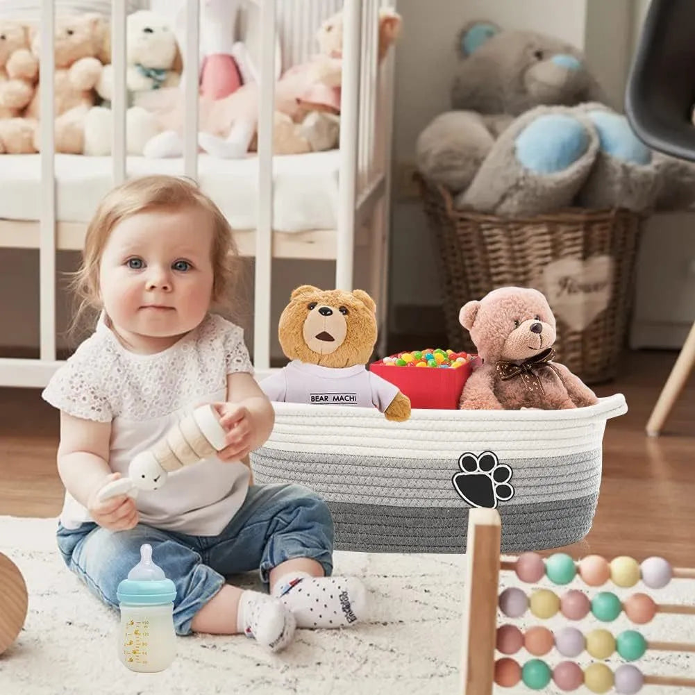 Handmade light beige woven cotton rope storage basket with wood and a handle.