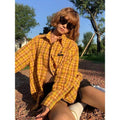 Dopamine yellow plaid shirt with loose cardigan fit on a hanger.
